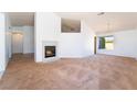 Bright living room with a fireplace and carpet flooring for a cozy feel at 2086 Angel Falls Dr, Henderson, NV 89074