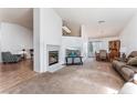 Spacious living room featuring a cozy fireplace, carpet floors, and ample natural light at 2086 Angel Falls Dr, Henderson, NV 89074