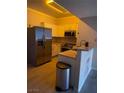 A modern kitchen with stainless steel appliances and light-colored cabinetry at 2151 Hussium Hills St # 207, Las Vegas, NV 89108