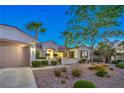 Charming single-story home featuring a two-car garage, well-manicured landscaping, and a welcoming entrance at 2319 Hardin Ridge Dr, Henderson, NV 89052