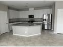 Spacious kitchen with white cabinets, granite countertops, and stainless steel appliances at 2456 Bagnara Pl, Henderson, NV 89044