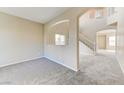 Spacious living room featuring neutral carpet, archways, and staircase at 3743 Prairie Orchid Ave, North Las Vegas, NV 89081