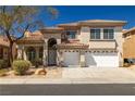 Charming two-story home with a red tile roof, manicured landscaping, and a spacious two-car garage at 4607 El Camino Cabos Dr, Las Vegas, NV 89147