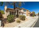Two-story home featuring a front yard with desert landscaping, and a two-car garage at 4607 El Camino Cabos Dr, Las Vegas, NV 89147