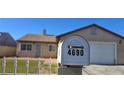 Close up of home address on mailbox, lawn and house slightly blurred in the background at 4690 E California Ave, Las Vegas, NV 89104