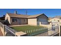 Street view of home with low water landscaping, security door, and attached garage at 4690 E California Ave, Las Vegas, NV 89104