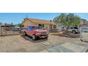 Wide view of a single story house with a truck and vehicles in the front and a chain link fence at 4835 Nevada Ave, Las Vegas, NV 89104