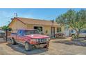 View of a single story house with a truck and vehicles in the front and a chain link fence at 4835 Nevada Ave, Las Vegas, NV 89104