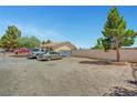 Street view of a single story house with multiple vehicles in the front and block wall at 4835 Nevada Ave, Las Vegas, NV 89104