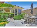 Inviting outdoor patio with decorative table and chairs, perfect for relaxing or entertaining guests at 5068 Rivedro St, Las Vegas, NV 89135