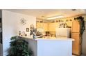 Bright kitchen with white appliances, breakfast bar, and ample counter space at 5415 W Harmon Ave # 2094, Las Vegas, NV 89103