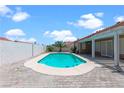Private in-ground pool surrounded by pavers, offering an inviting space for relaxation and recreation with a covered patio at 608 Blooming View Ave, North Las Vegas, NV 89032