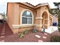 Charming home with desert landscaping, stone accents, and an arched entry at 6339 Sharp Rock Ct, Las Vegas, NV 89139