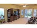Spacious living room with entertainment center and brown leather reclining seating at 6339 Sharp Rock Ct, Las Vegas, NV 89139