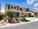 Charming two-story home with a three-car garage, desert landscaping, and a paved driveway at 6465 Grande River Ct, Las Vegas, NV 89139