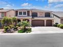 Charming two-story home with a three-car garage, desert landscaping, and a paved driveway at 6465 Grande River Ct, Las Vegas, NV 89139