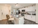 Modern kitchen features white cabinets, granite countertops, and stainless steel appliances at 6835 Orange Horizon St, North Las Vegas, NV 89086