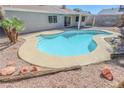 Inviting backyard pool featuring a unique design, surrounded by desert landscaping at 6842 Greengrove Dr, Las Vegas, NV 89103
