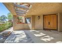 Inviting entryway with double doors and a concrete patio at 7296 Mission Hills Dr, Las Vegas, NV 89113