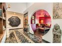 Unique foyer featuring marble floors, intricate wood carvings, and arched doorway at 7296 Mission Hills Dr, Las Vegas, NV 89113