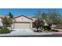 Traditional-style home with desert landscaping, a two-car garage, and neutral stucco at 7448 Lintwhite St, North Las Vegas, NV 89084