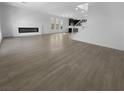 Bright living room featuring an electric fireplace and wood-look flooring at 7791 Misty Oaks Ave, Las Vegas, NV 89113