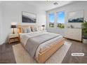 Well-lit main bedroom featuring a bed, two end tables, two windows, and a dresser at 7791 Misty Oaks Ave, Las Vegas, NV 89113