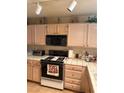 Functional kitchen featuring light wood cabinetry, white countertops, and essential appliances at 7950 W Flamingo Rd # 2074, Las Vegas, NV 89147