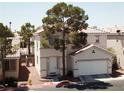 Inviting two-story home with a charming front yard, showcasing its appealing curb appeal at 971 Whispering Grove Ave, Las Vegas, NV 89123