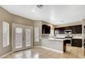 Modern kitchen featuring dark cabinets, stainless steel appliances, and elegant countertops at 971 Whispering Grove Ave, Las Vegas, NV 89123