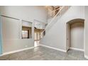 Open concept living room with tile flooring, a staircase, and neutral paint at 971 Whispering Grove Ave, Las Vegas, NV 89123