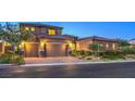 Beautiful two-story home with a three-car garage and meticulously landscaped front yard and a brick driveway at 9760 Arch Canyon Ct, Las Vegas, NV 89149