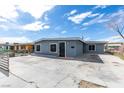 Charming single-story house featuring a gray exterior, a large front yard, and off-street parking at 1013 Cunningham Dr, Las Vegas, NV 89106