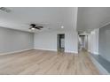 Bright living room featuring new floors, a ceiling fan, and gray paint at 1013 Cunningham Dr, Las Vegas, NV 89106