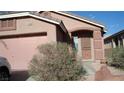 Charming single-story home with a stucco facade, arched entryway, and a well-manicured front yard at 10220 Arlington Abby St, Las Vegas, NV 89183