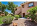 Condo exterior featuring manicured landscaping, mature trees, and private entrances at 1050 E Cactus Ave # 1128, Las Vegas, NV 89183