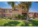 Beautiful condo building with well-maintained landscaping and a lush lawn at 1050 E Cactus Ave # 1128, Las Vegas, NV 89183