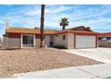 Single-story home featuring desert landscaping and a beige and red exterior paint scheme at 1158 E Hacienda Ave, Las Vegas, NV 89119