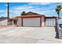 Single-story home featuring a two-car garage, desert landscaping, and a white exterior at 1158 E Hacienda Ave, Las Vegas, NV 89119
