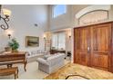 Welcoming home foyer boasts soaring ceilings, tiled floors, and a double door entry at 1182 Thomas Bay Cir, Logandale, NV 89021