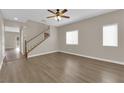 Inviting living room with hardwood flooring and a staircase at 125 Sharp Edge Ave, North Las Vegas, NV 89031
