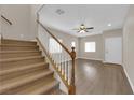Open-concept living space with hardwood floors and staircase at 125 Sharp Edge Ave, North Las Vegas, NV 89031