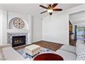 Stylish living room features a fireplace, wood floors, and comfortable seating arrangement at 1520 Della Ct, Boulder City, NV 89005