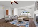 Bright living room featuring vaulted ceiling, wood floors, statement window, and comfortable seating at 1520 Della Ct, Boulder City, NV 89005