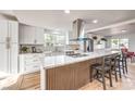 Bright kitchen features white cabinets, stainless appliances and large island with seating at 1731 Sherwin Ln, Las Vegas, NV 89156