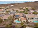 Bird's-eye view of a home with a private pool, solar panels, and desert landscape at 2151 Bannerwood St, Henderson, NV 89044