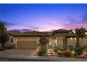 Lovely home showcasing a front entrance with stone accents, lush greenery, and a three car garage at 2151 Bannerwood St, Henderson, NV 89044