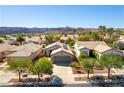 Charming single-story home with desert landscaping, mature trees, and a two car garage nestled in a quiet neighborhood at 2185 High Mesa Dr, Henderson, NV 89012