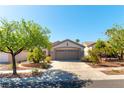Well maintained home with a two car garage, mature trees and desert landscaping at 2185 High Mesa Dr, Henderson, NV 89012