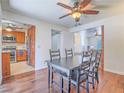 Cozy dining room features hardwood floors and space for seating, adjacent to kitchen at 2462 Pickwick Dr, Henderson, NV 89014